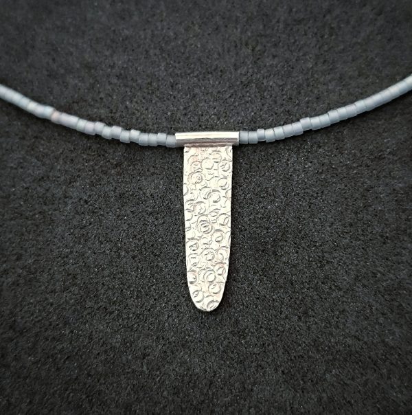 Silver pendant with glass beads