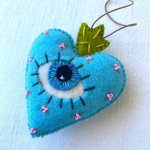 Beautiful the 'All-Seeing Heart' Ornament: A sea-blue heart ornament. - Image 3