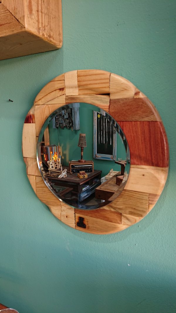 Round, carved, multi wood framed mirror