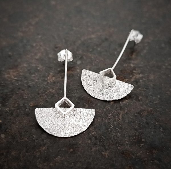 silver earrings with geometric patterns