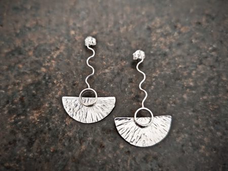 silver earrings with geometric patterns