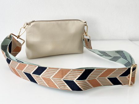 beige messenger bag with chevrons strap front