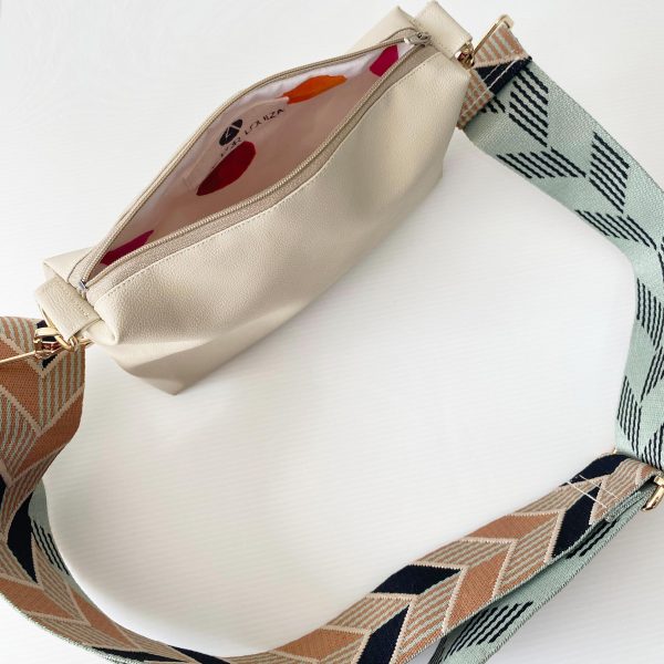 beige messenger bag with chevrons strap inside
