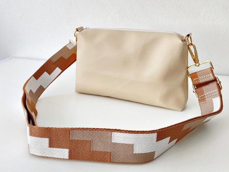 beige messenger bag with geometric strap front