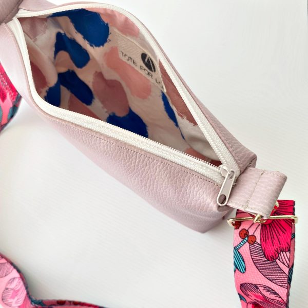 pink messenger bag with floral strap inside