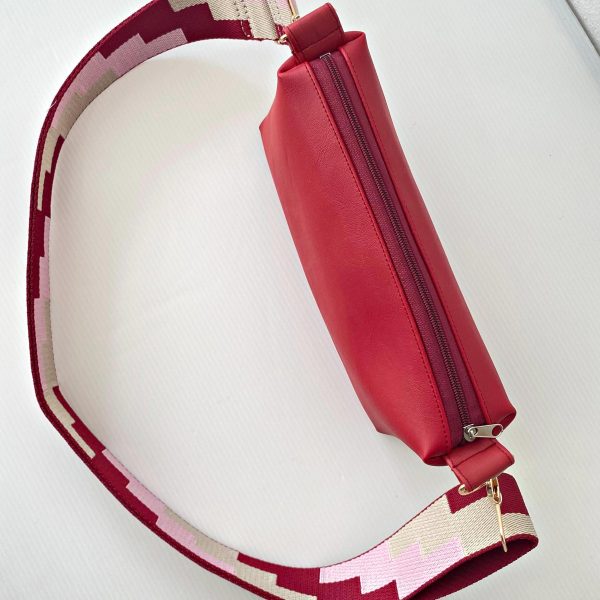 red messenger bag with geometric strap top